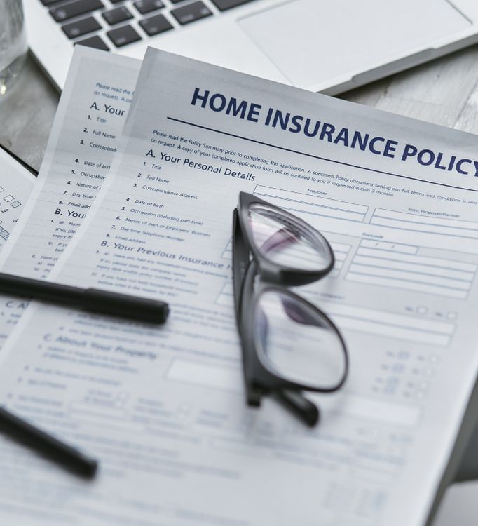 Home insurance document with reading glasses